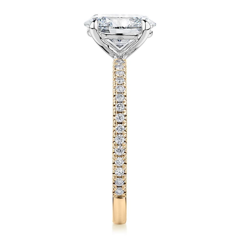 Signature Simulant Diamond 1.74 carat* TW oval and round brilliant shouldered engagement ring in 14 carat yellow and white gold