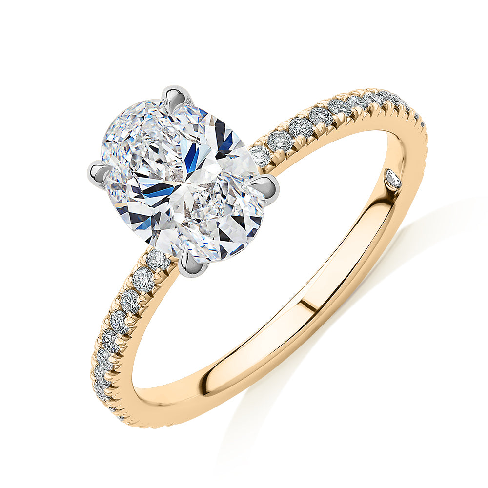 Signature Simulant Diamond 1.74 carat* TW oval and round brilliant shouldered engagement ring in 14 carat yellow and white gold