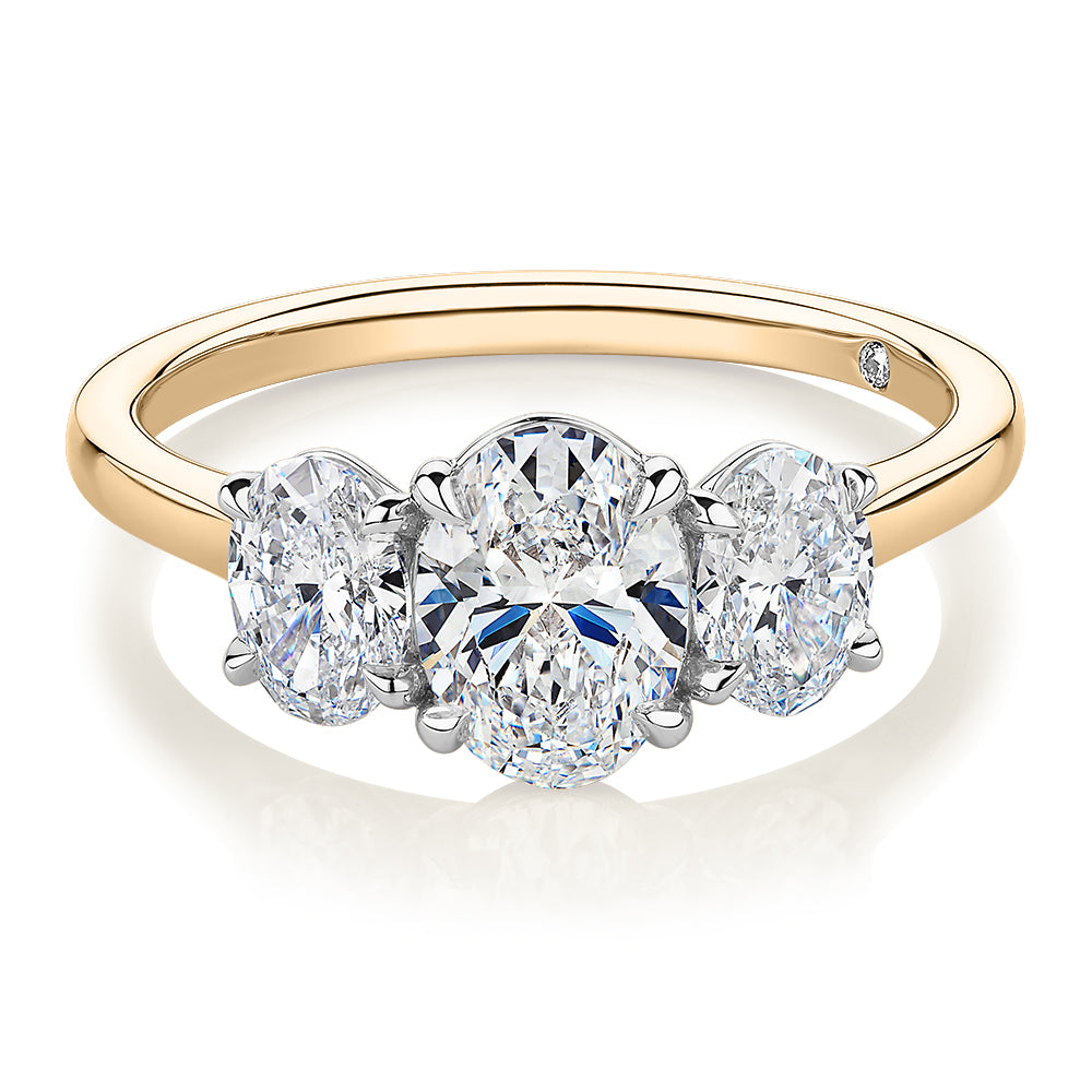 Signature Simulant Diamond 1.87 carat* TW oval three stone ring in 14 carat yellow and white gold