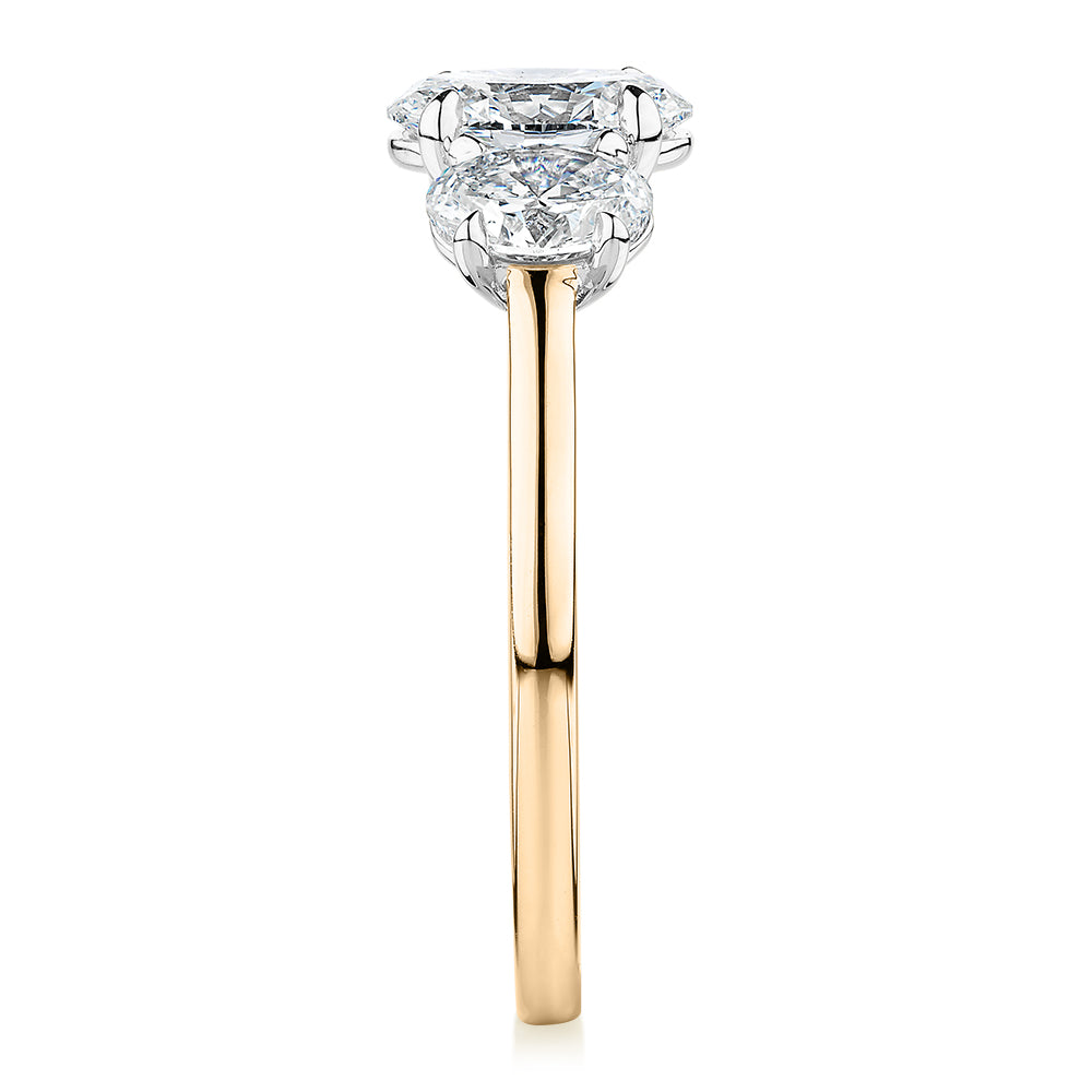 Signature Simulant Diamond 1.87 carat* TW oval three stone ring in 14 carat yellow and white gold