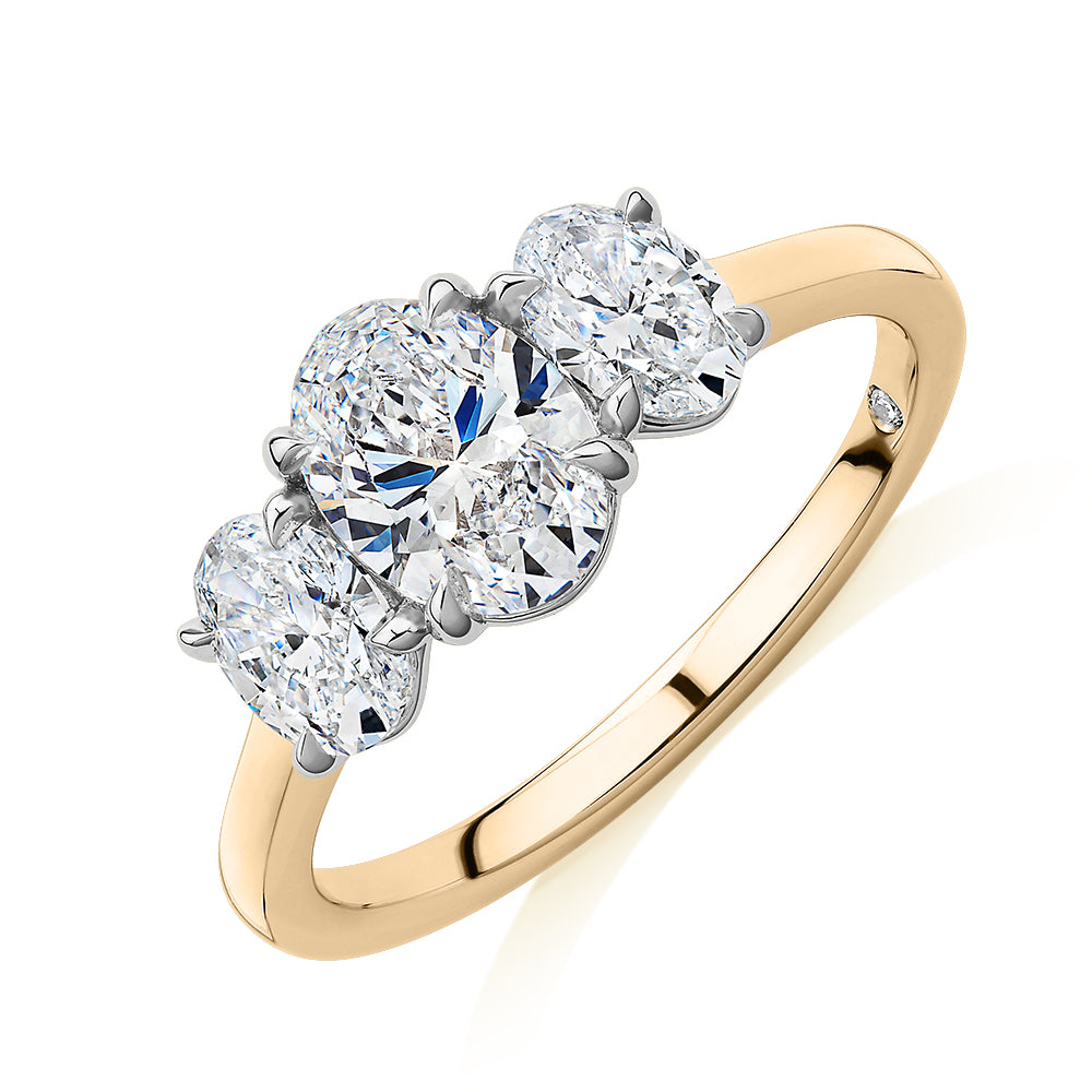 Signature Simulant Diamond 1.87 carat* TW oval three stone ring in 14 carat yellow and white gold