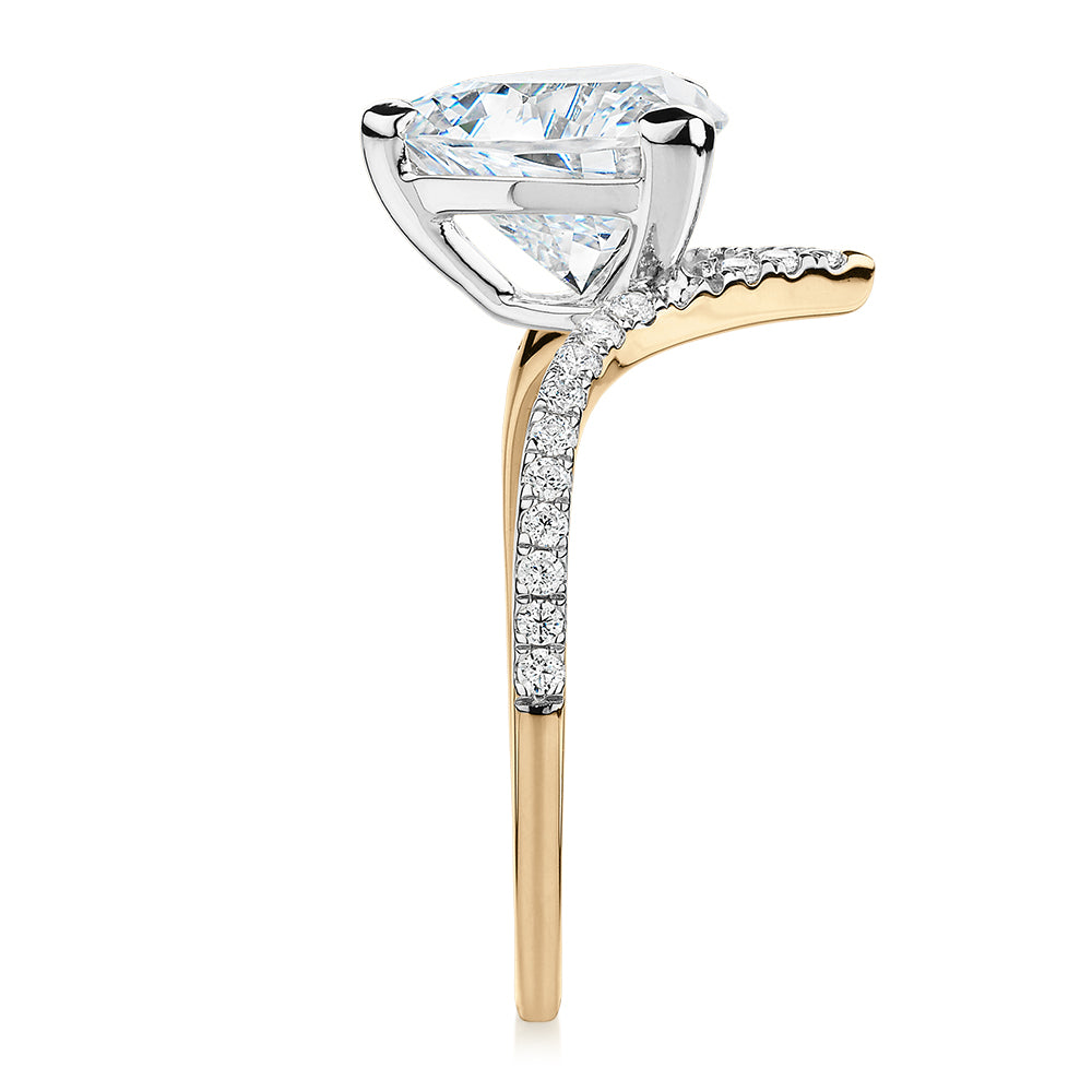 Trilliant and Round Brilliant shouldered engagement ring with 2.52 carats* of diamond simulants in 14 carat yellow and white gold