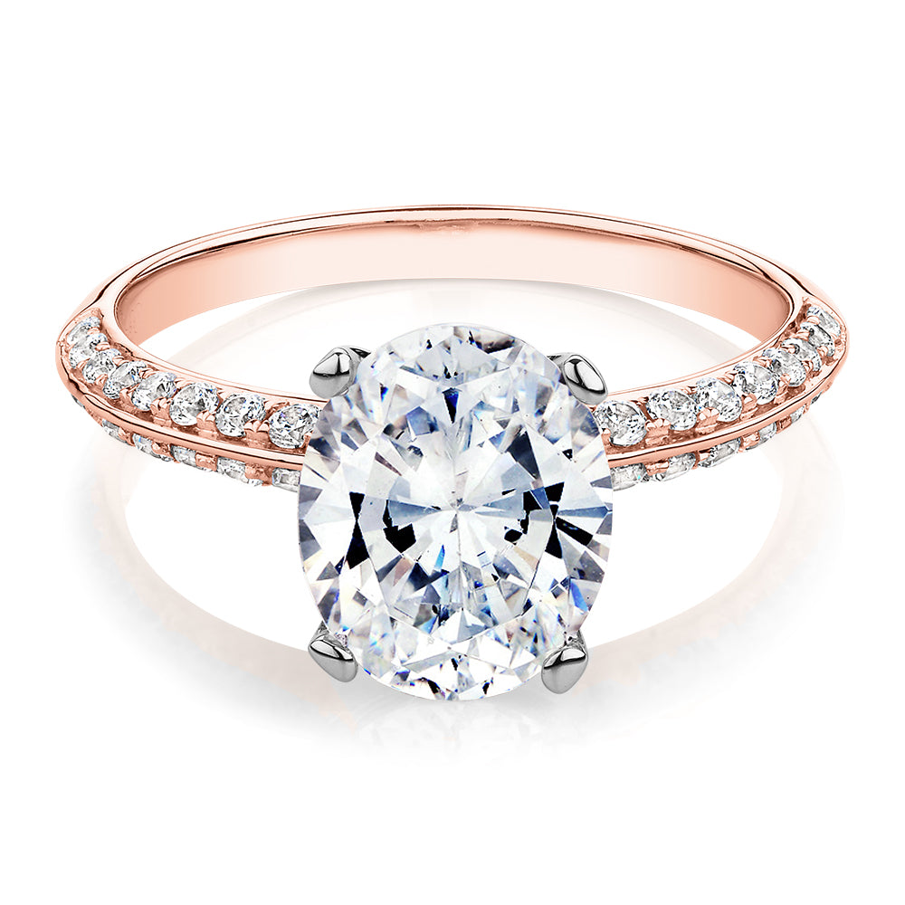 Oval shouldered engagement ring with 2.97 carats* of diamond simulants in 14 carat rose and white gold