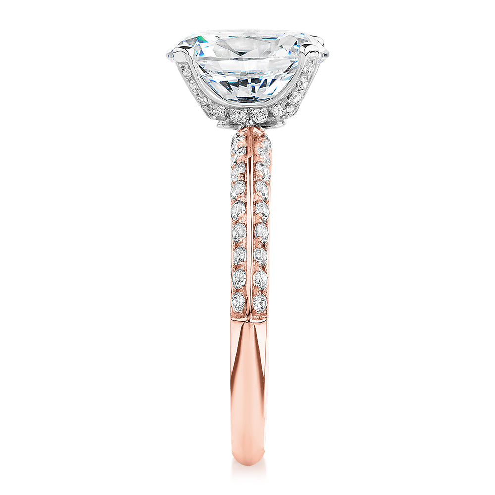 Oval shouldered engagement ring with 2.97 carats* of diamond simulants in 14 carat rose and white gold
