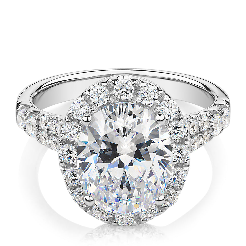 Oval and Round Brilliant halo engagement ring with 4.61 carats* of diamond simulants in 10 carat white gold