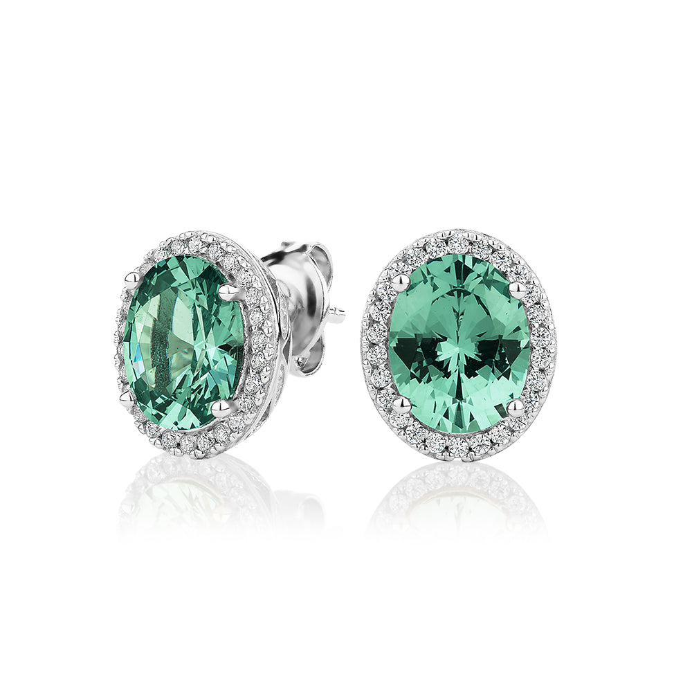 Oval and Round Brilliant halo stud earrings with ocean green simulants and 0.34 carats* of diamond simulants