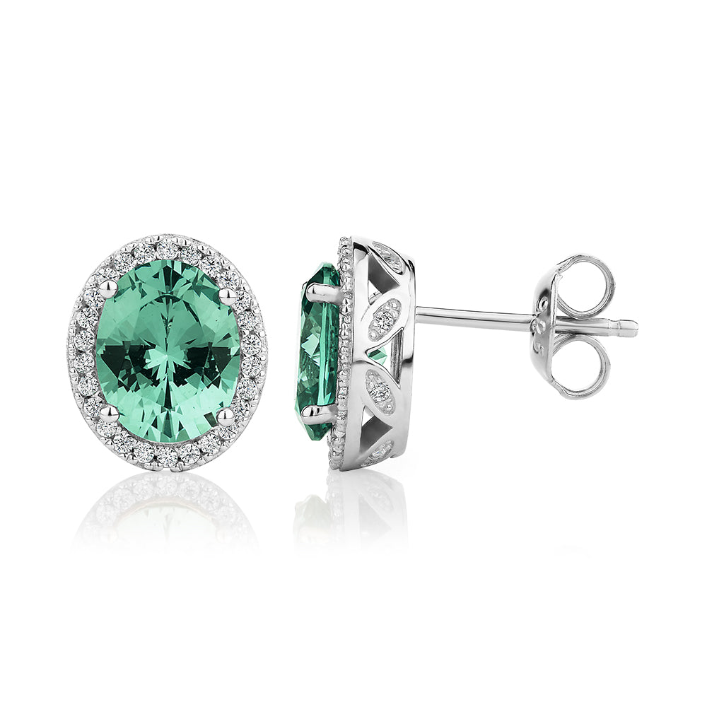 Oval and Round Brilliant halo stud earrings with ocean green simulants and 0.34 carats* of diamond simulants