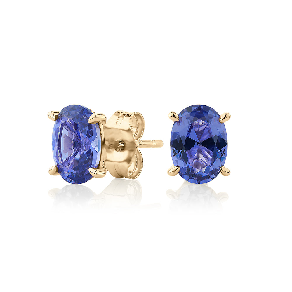 Oval stud earrings with tanzanite simulants in 10 carat yellow gold