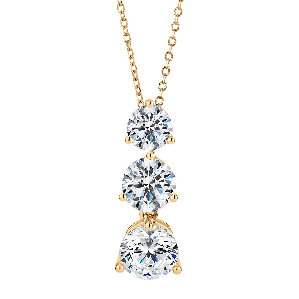 Three stone drop pendant with 2.33 carats* of diamond simulants in 10 carat yellow gold