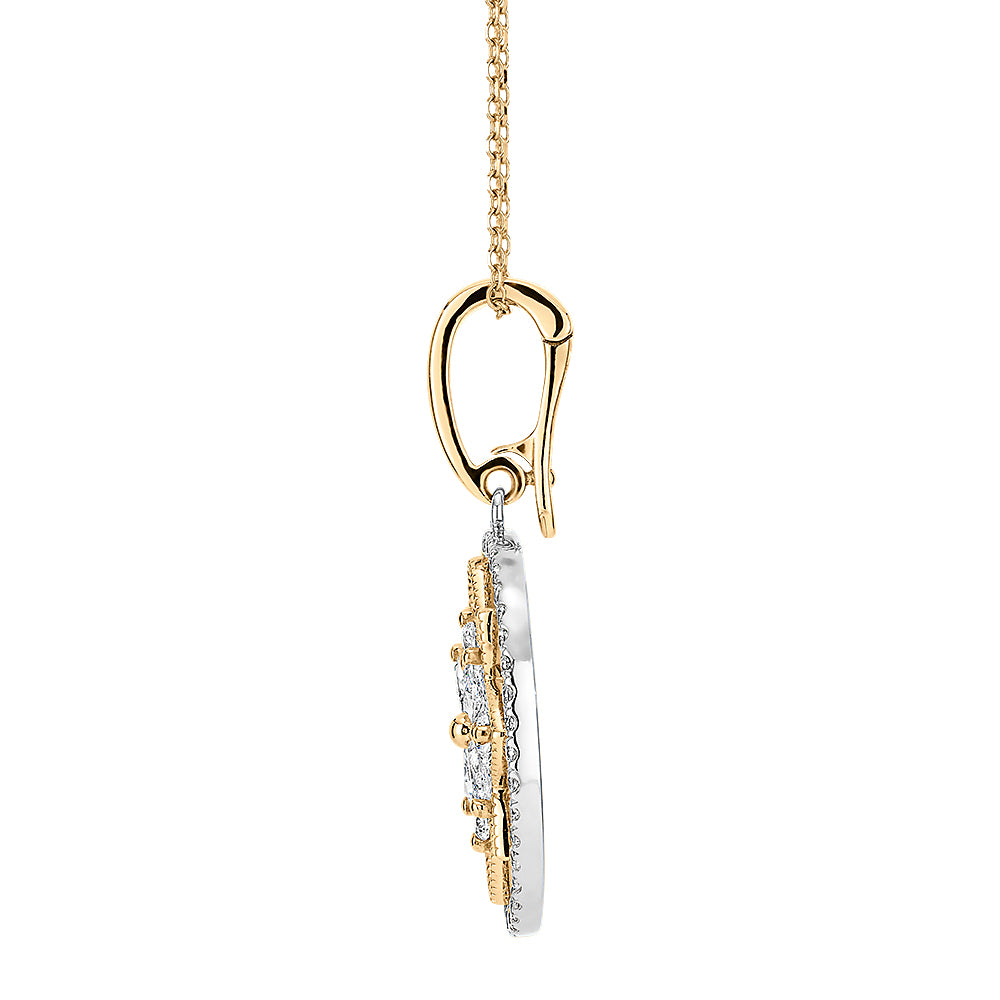 Fancy pendant with 0.64 carats* of diamond simulants in 10 carat yellow gold and sterling silver