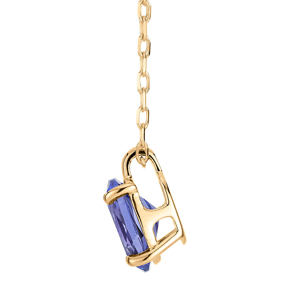 Oval solitaire pendant with tanzanite simulant in 10 carat yellow gold