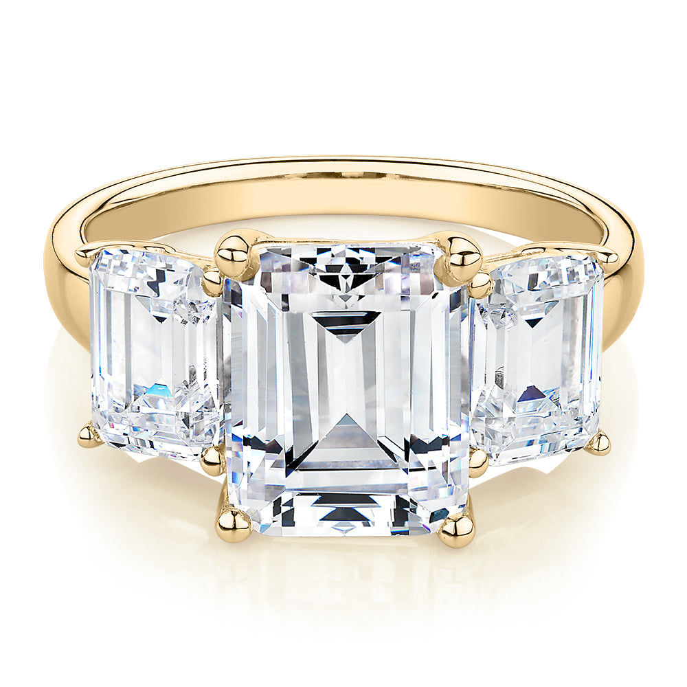 Three stone ring with 4.9 carats* of diamond simulants in 10 carat yellow gold