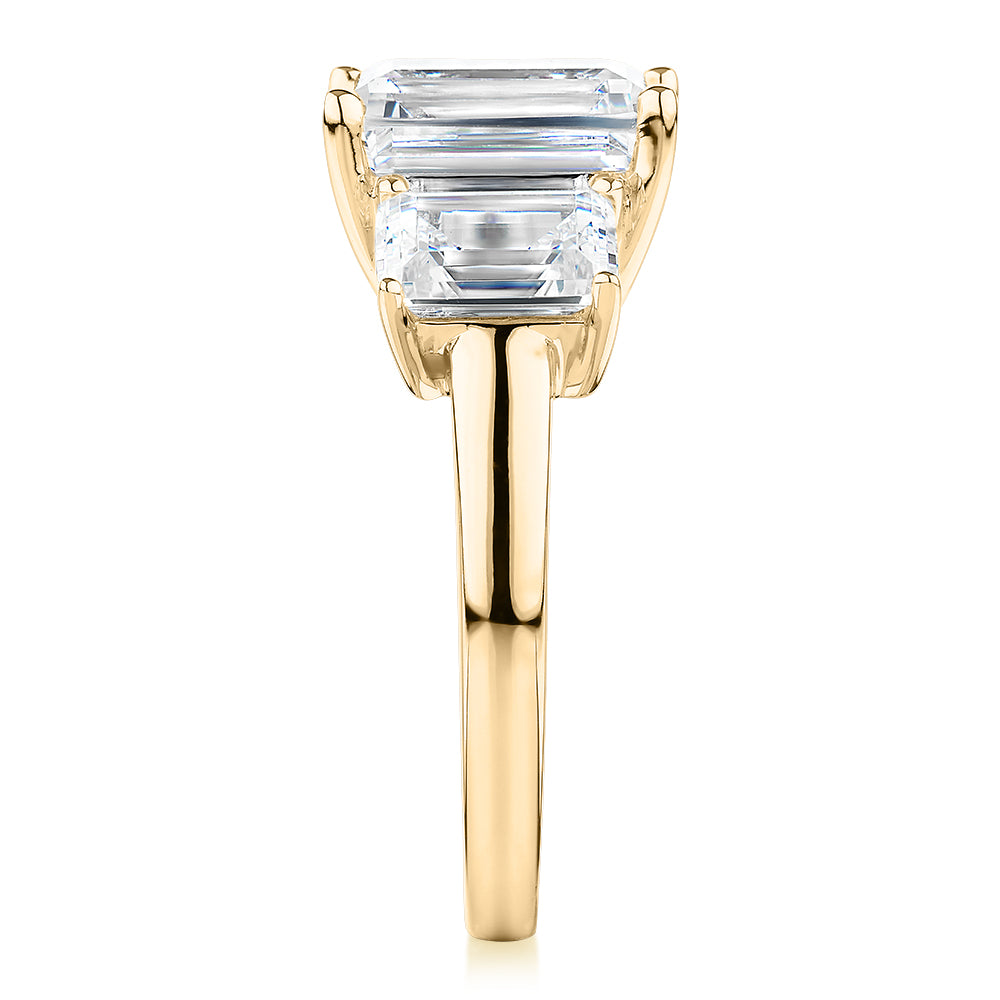 Three stone ring with 4.9 carats* of diamond simulants in 10 carat yellow gold