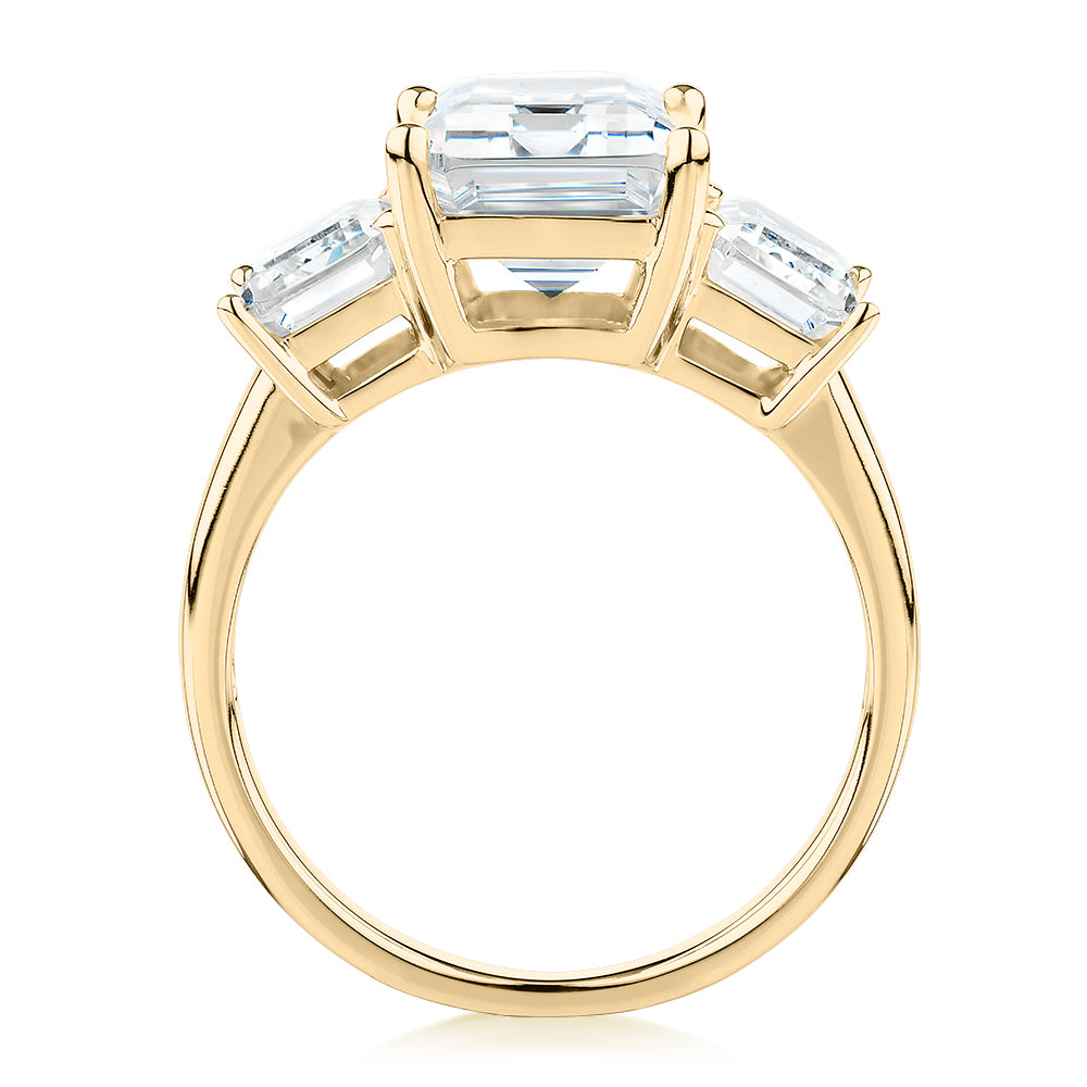 Three stone ring with 4.9 carats* of diamond simulants in 10 carat yellow gold