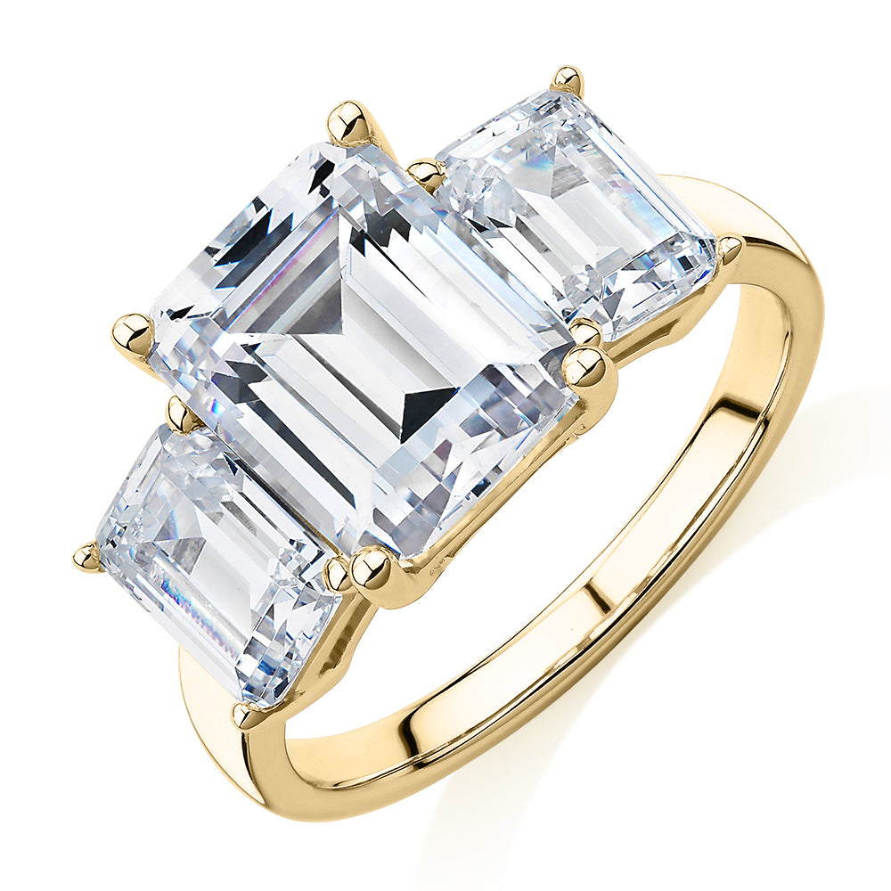Three stone ring with 4.9 carats* of diamond simulants in 10 carat yellow gold