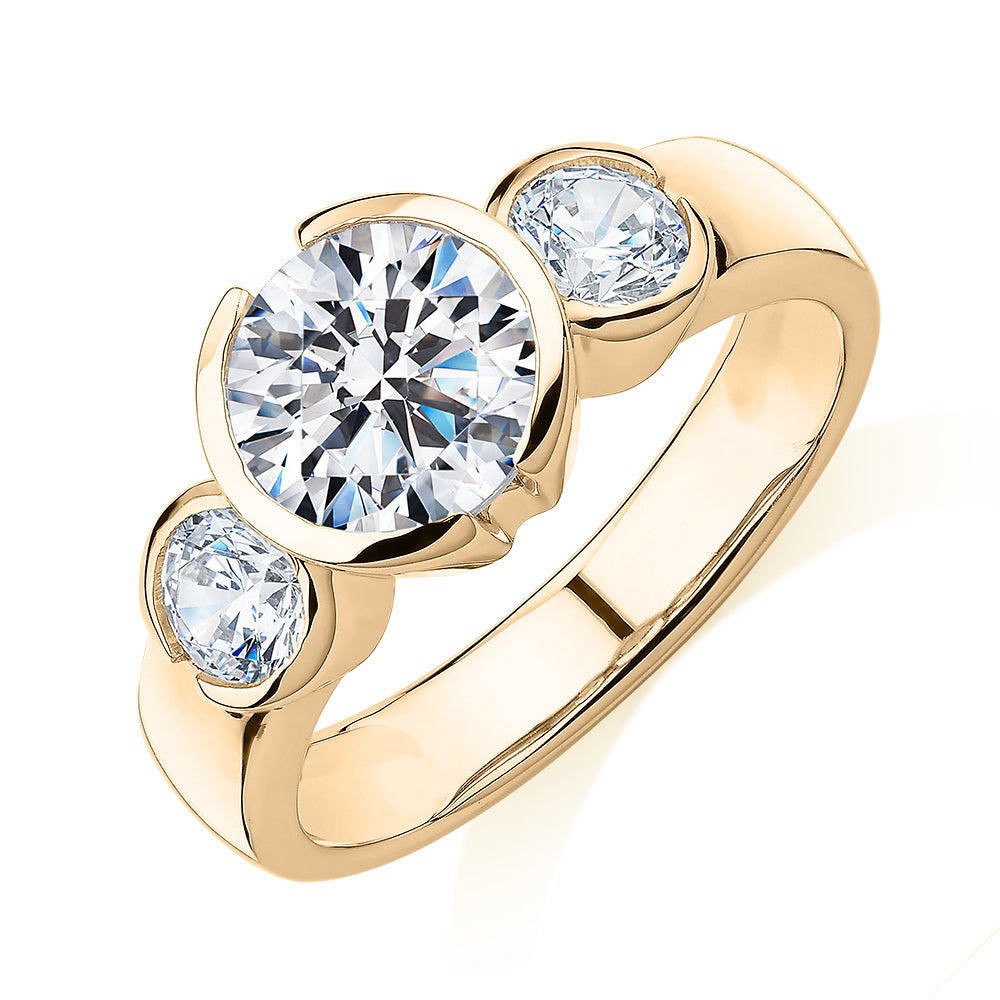 Three stone ring with 2.23 carats* of diamond simulants in 10 carat yellow gold