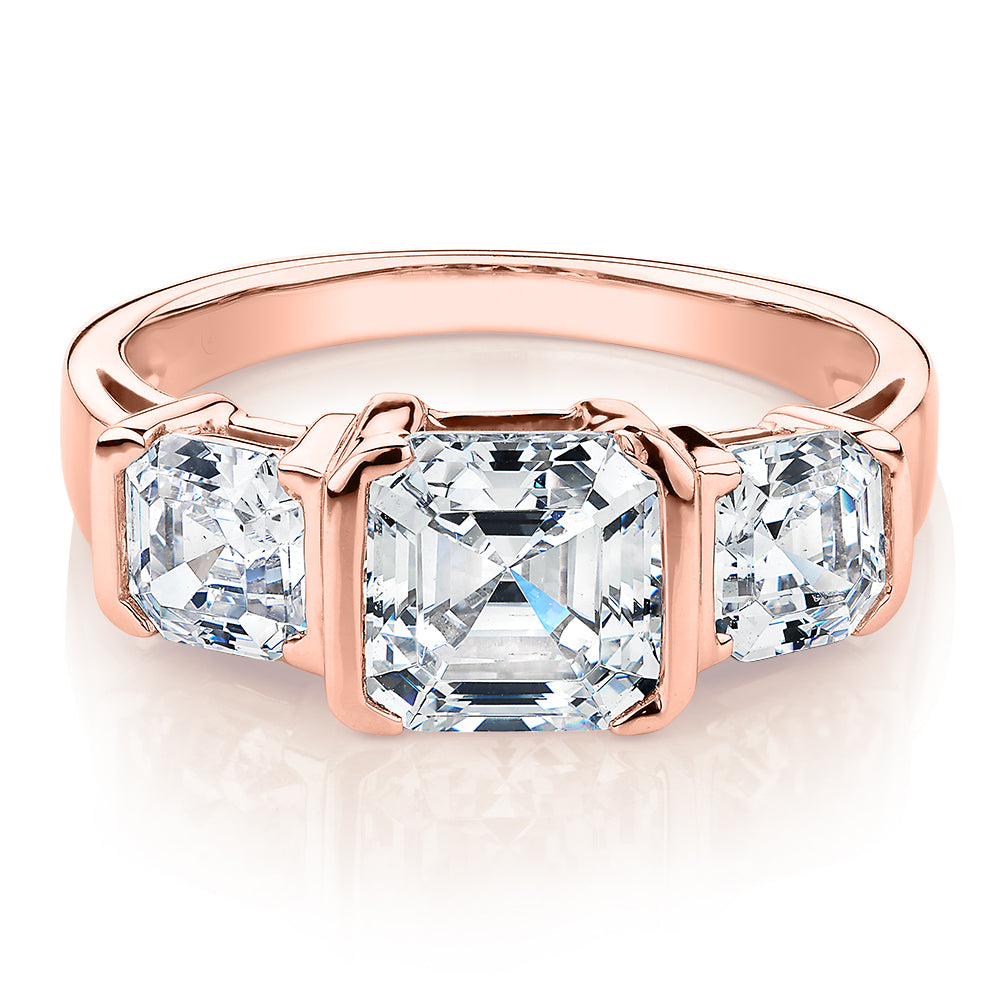 Three stone ring with carats* of diamond simulants in 10 carat rose  gold