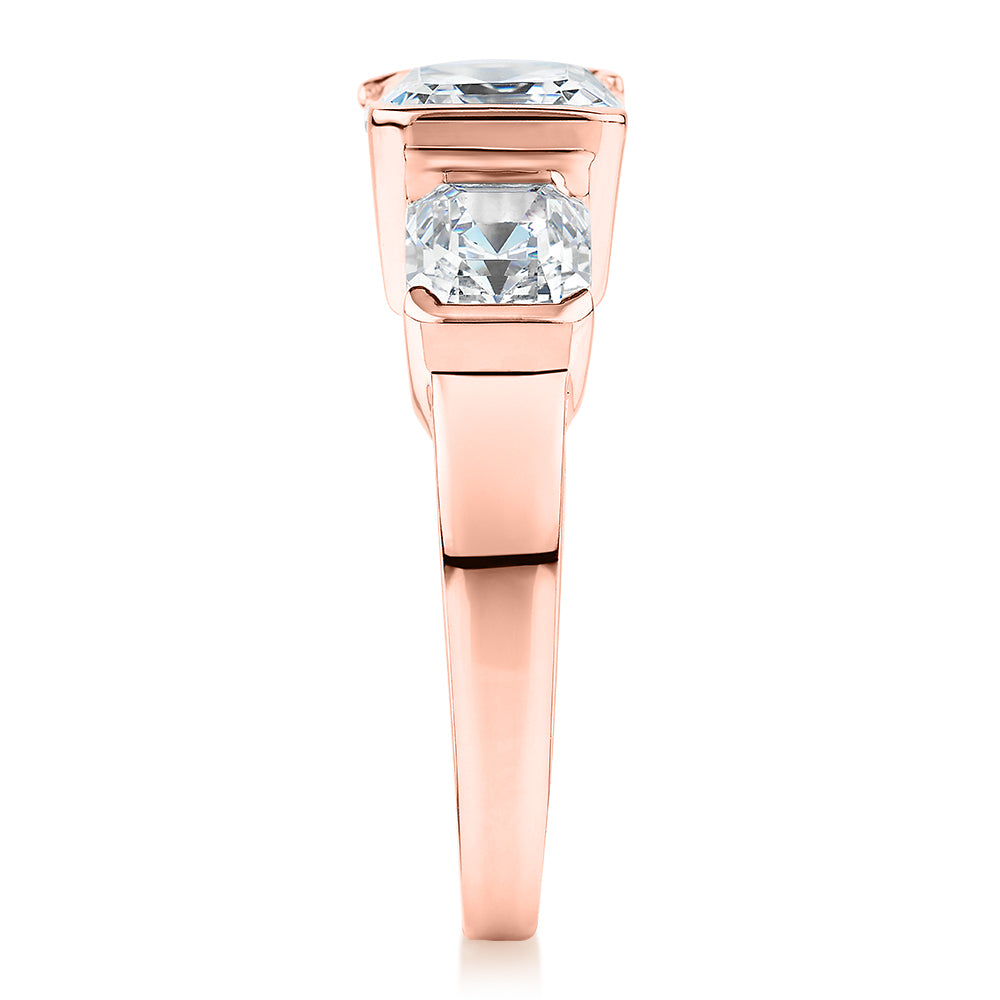 Three stone ring with 3.38 carats* of diamond simulants in 10 carat rose gold