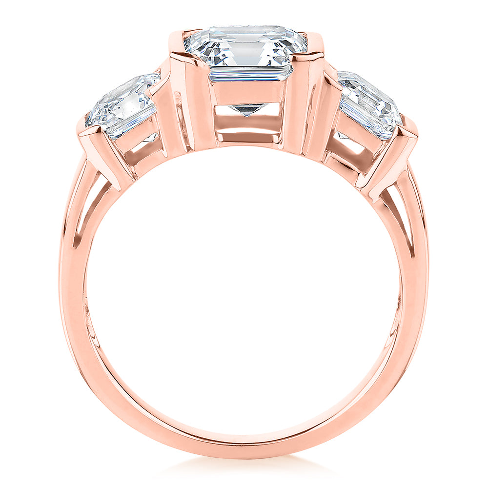 Three stone ring with 3.38 carats* of diamond simulants in 10 carat rose gold