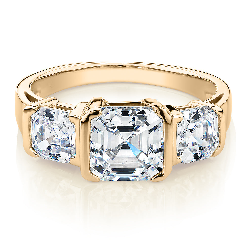 Three stone ring with 3.38 carats* of diamond simulants in 10 carat yellow gold