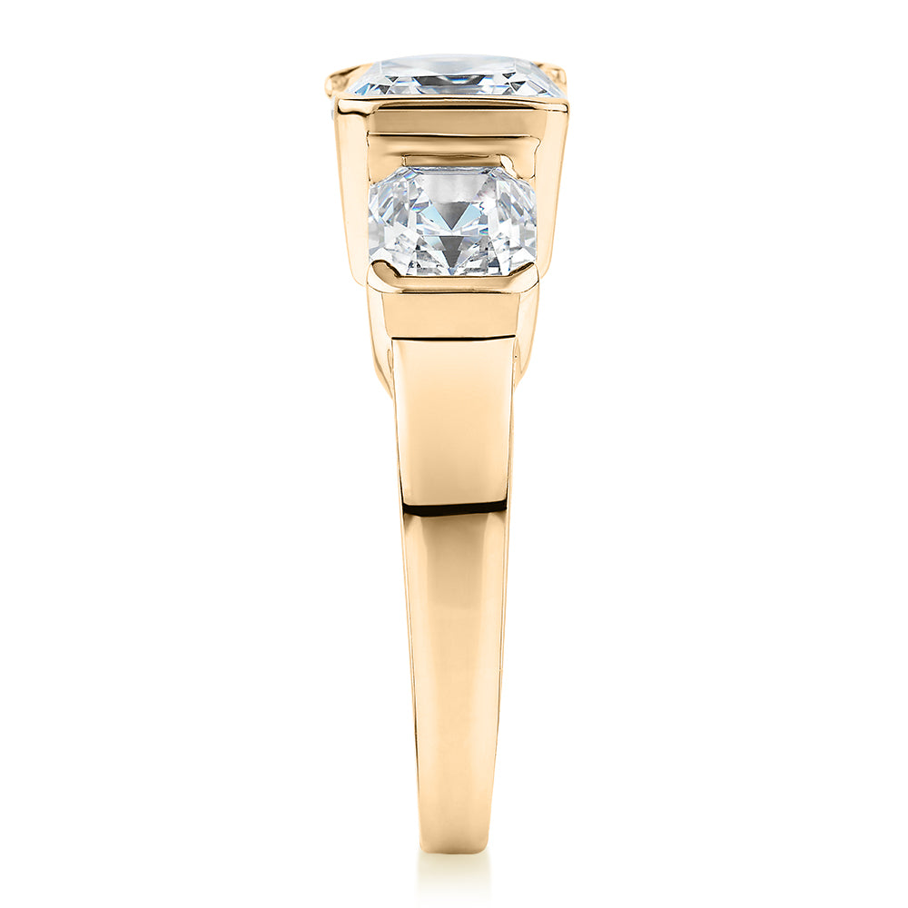 Three stone ring with 3.38 carats* of diamond simulants in 10 carat yellow gold