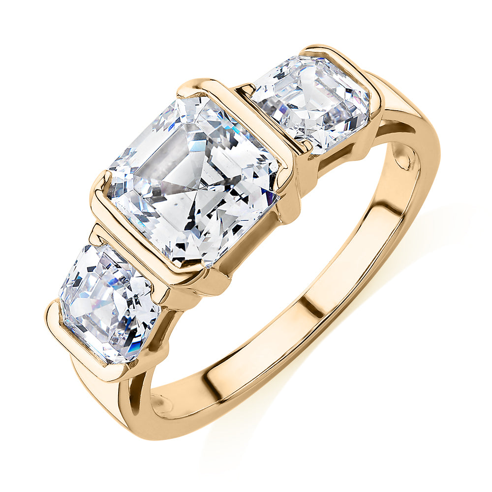Three stone ring with 3.38 carats* of diamond simulants in 10 carat yellow gold