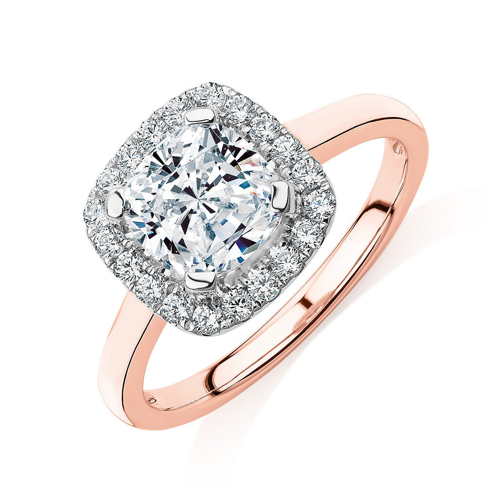 Cushion and Round Brilliant halo engagement ring with 1.58 carats* of diamond simulants in 10 carat rose and white gold