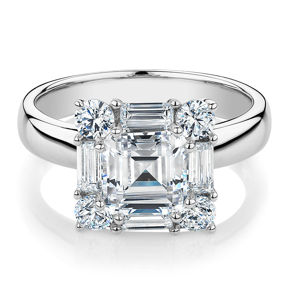 Princess Cut, Baguette and Round Brilliant halo engagement ring with carats* of diamond simulants in 10 carat white gold