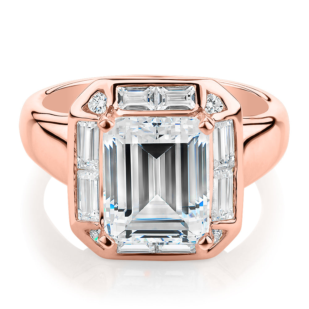 Emerald Cut, Baguette and Round Brilliant halo engagement ring with 4.53 carats* of diamond simulants in 10 carat rose gold