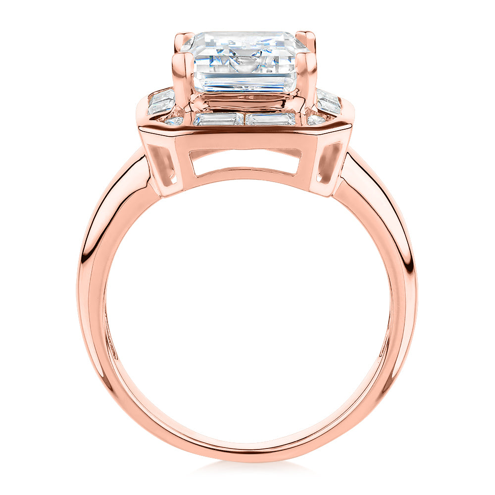 Emerald Cut, Baguette and Round Brilliant halo engagement ring with 4.53 carats* of diamond simulants in 10 carat rose gold