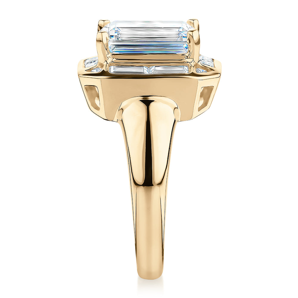 Emerald Cut, Baguette and Round Brilliant halo engagement ring with 4.53 carats* of diamond simulants in 10 carat yellow gold