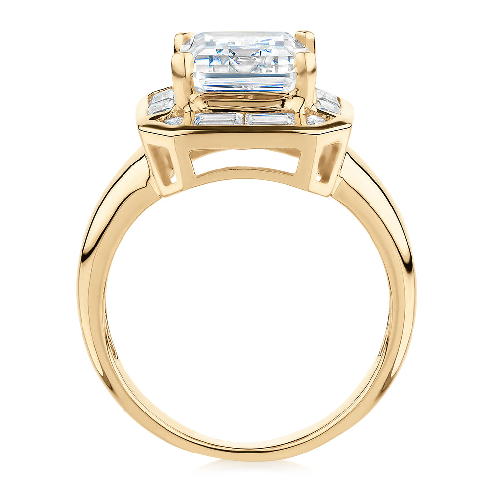 Emerald Cut, Baguette and Round Brilliant halo engagement ring with 4.53 carats* of diamond simulants in 10 carat yellow gold