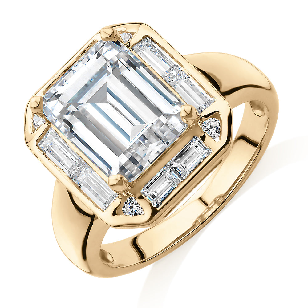 Emerald Cut, Baguette and Round Brilliant halo engagement ring with 4.53 carats* of diamond simulants in 10 carat yellow gold