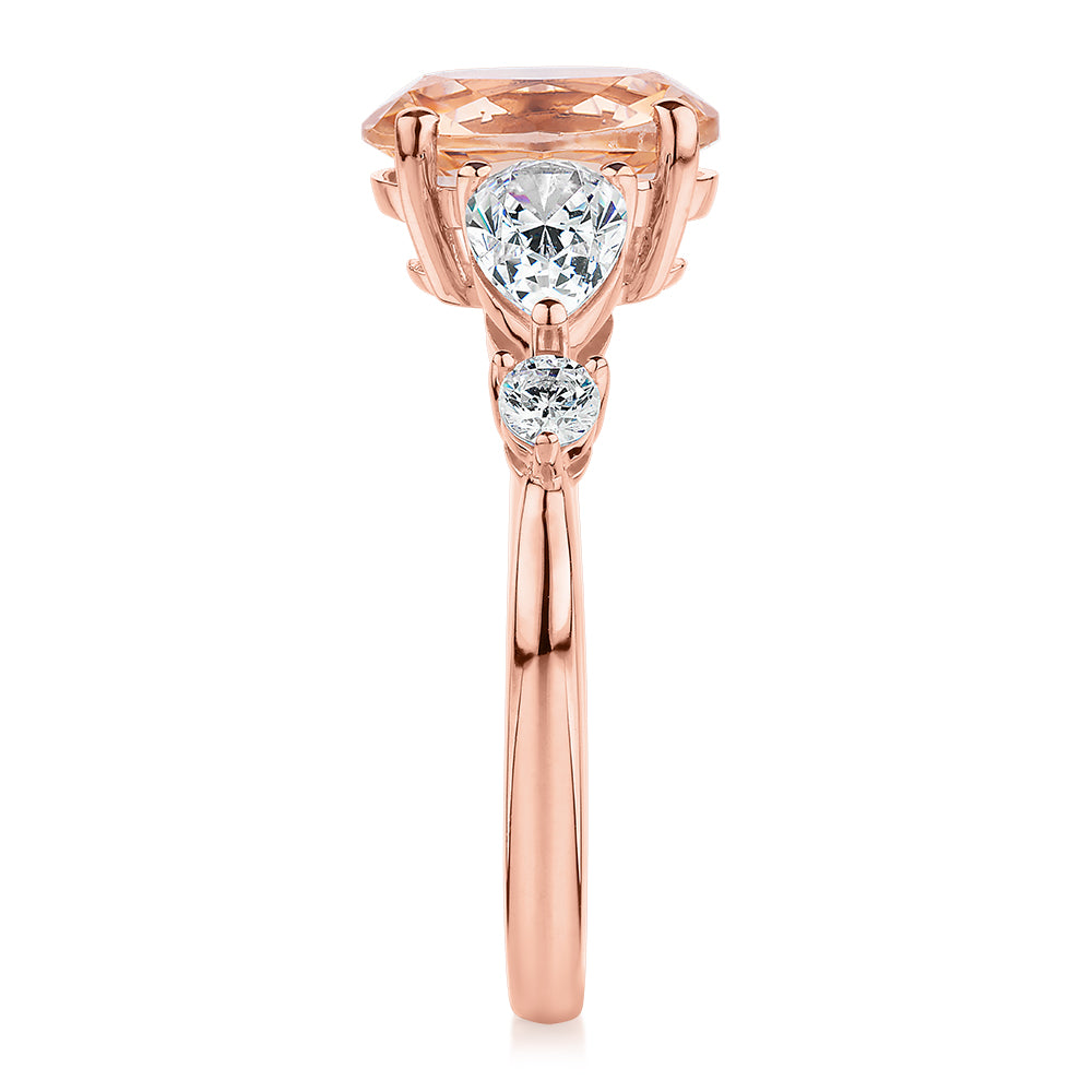 Oval, Pear and Round Brilliant shouldered engagement ring with morganite simulant and 0.90 carats* of diamond simulants in 10 carat rose gold