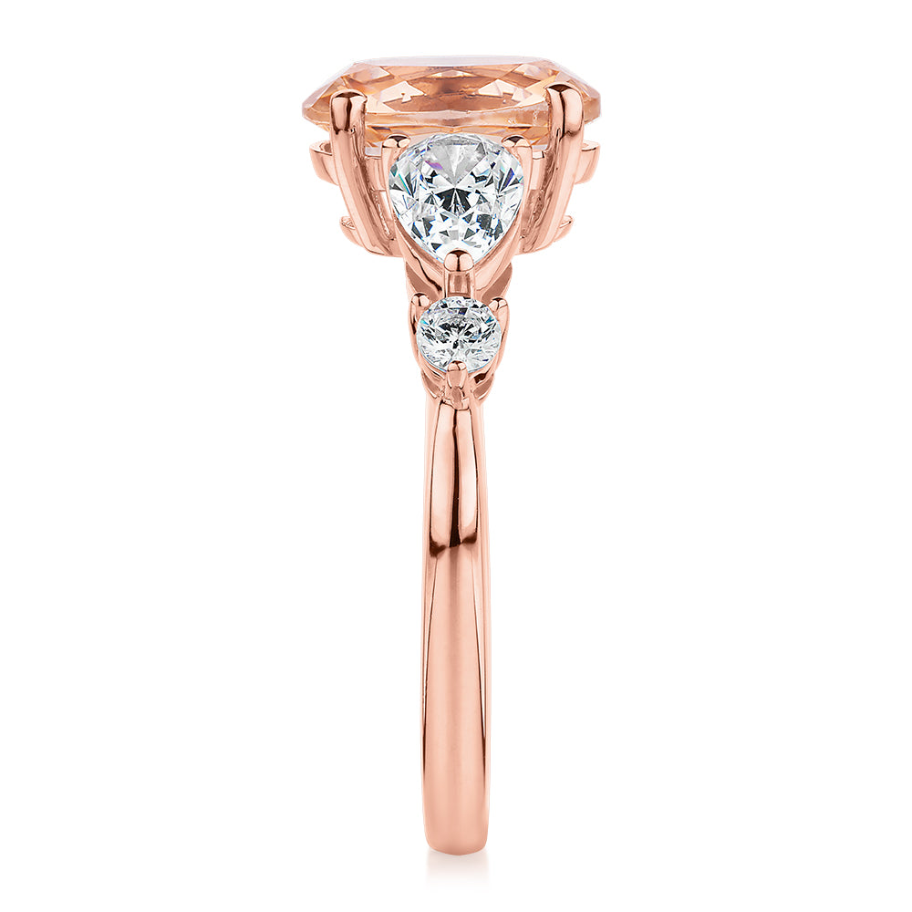 Oval, Pear and Round Brilliant shouldered engagement ring with morganite simulant and 0.90 carats* of diamond simulants in 10 carat rose gold