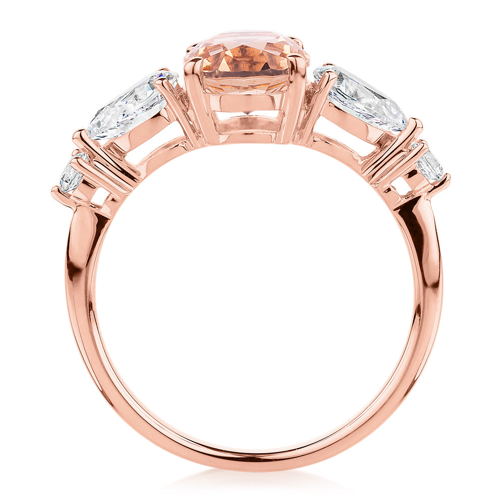 Oval, Pear and Round Brilliant shouldered engagement ring with morganite simulant and 0.90 carats* of diamond simulants in 10 carat rose gold