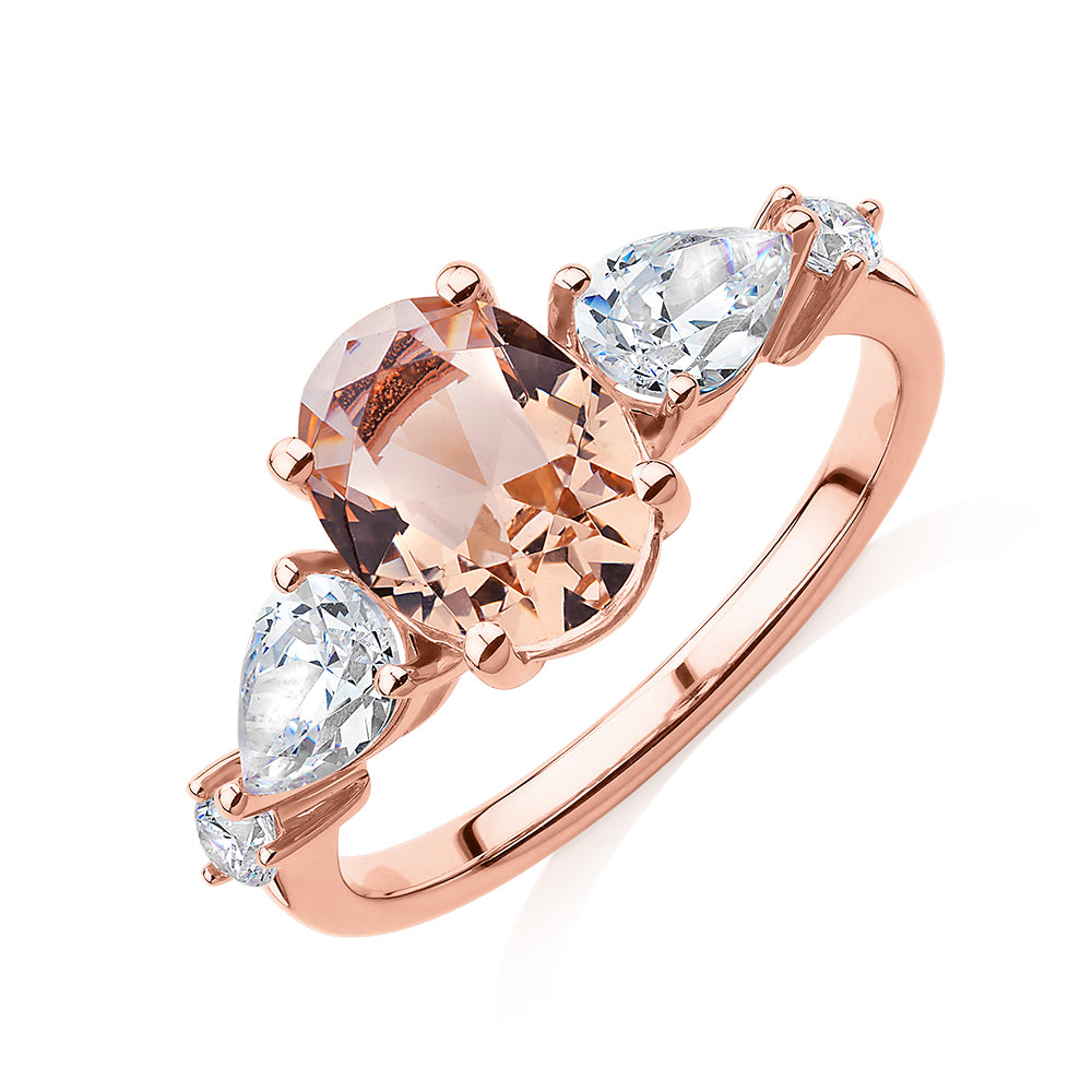 Oval, Pear and Round Brilliant shouldered engagement ring with morganite simulant and 0.90 carats* of diamond simulants in 10 carat rose gold