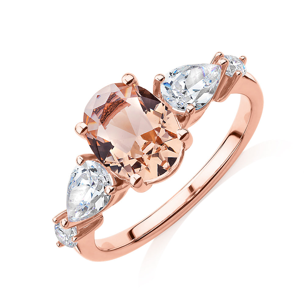 Oval, Pear and Round Brilliant shouldered engagement ring with morganite simulant and 0.90 carats* of diamond simulants in 10 carat rose gold