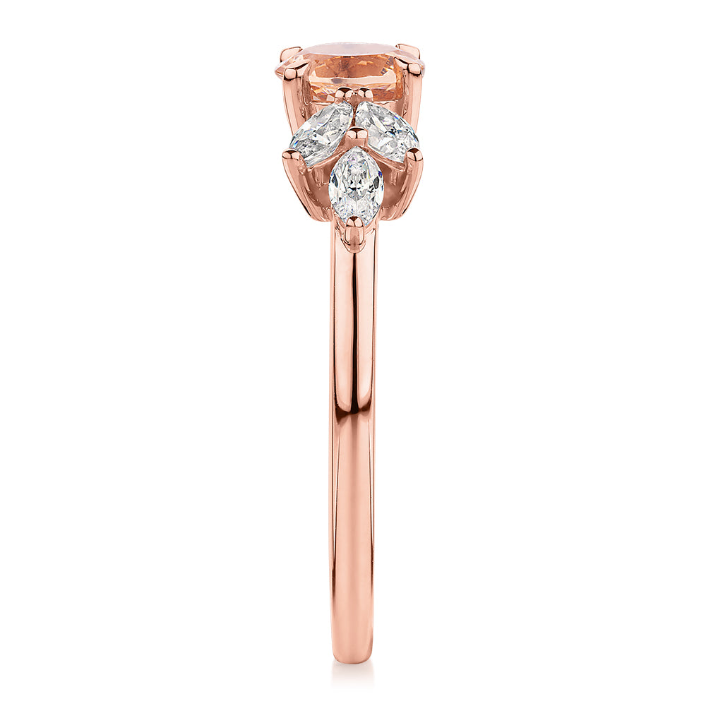Round Brilliant and Marquise shouldered engagement ring with morganite simulant and 0.33 carats* of diamond simulants in 10 carat rose gold