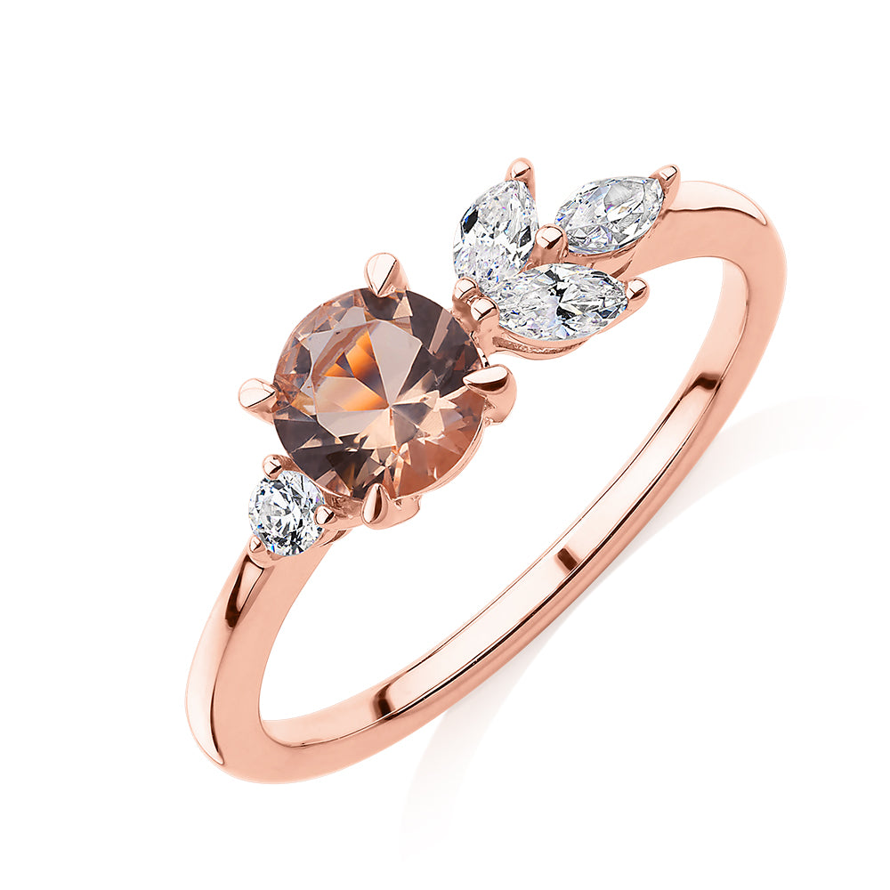 Round Brilliant and Marquise shouldered engagement ring with morganite simulant and 0.33 carats* of diamond simulants in 10 carat rose gold