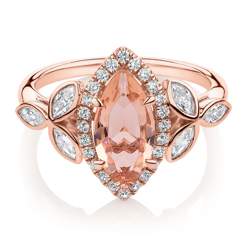 Marquise and Round Brilliant halo engagement ring with morganite simulant and 0.84 carats* of diamond simulants in 10 carat rose gold