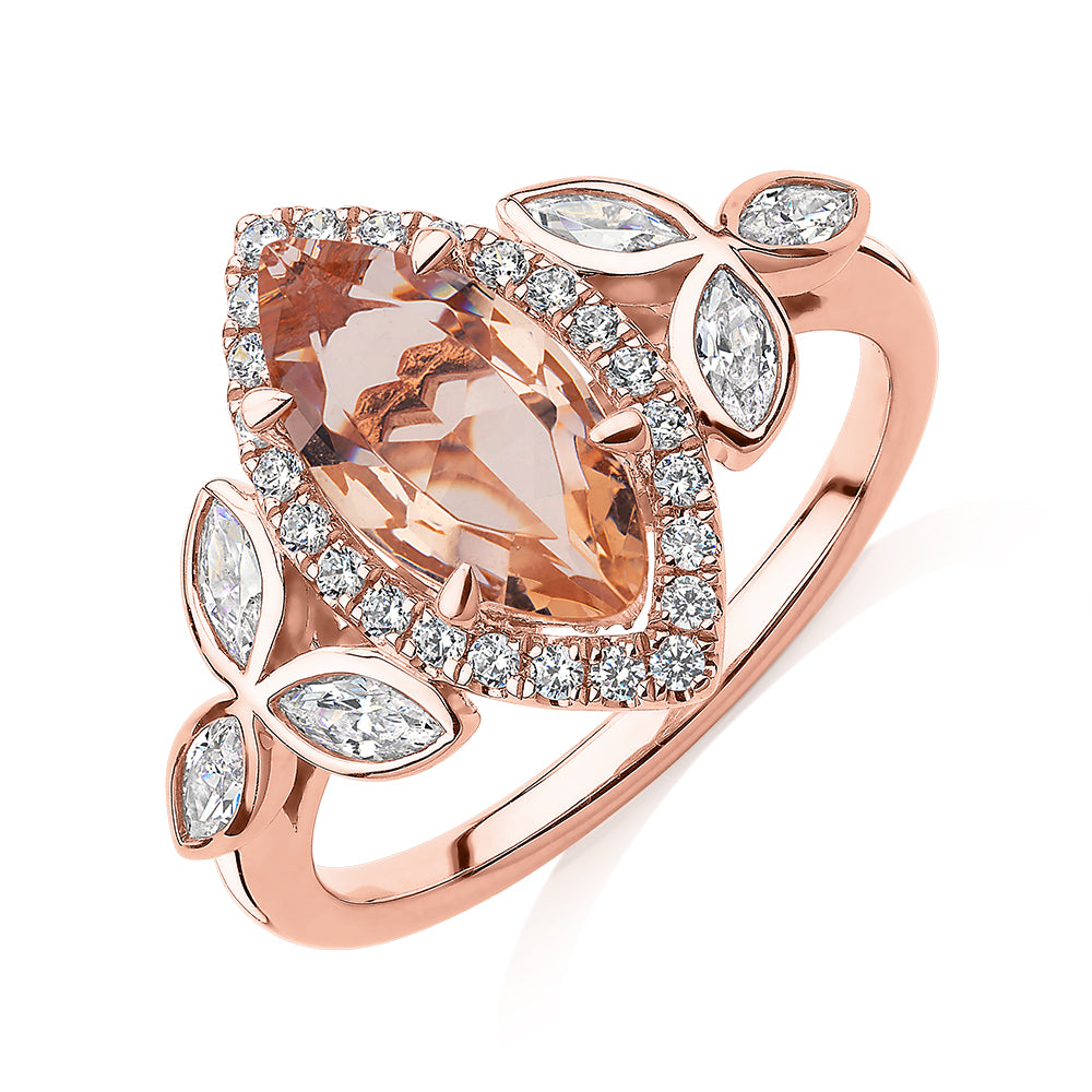 Marquise and Round Brilliant halo engagement ring with morganite simulant and 0.84 carats* of diamond simulants in 10 carat rose gold