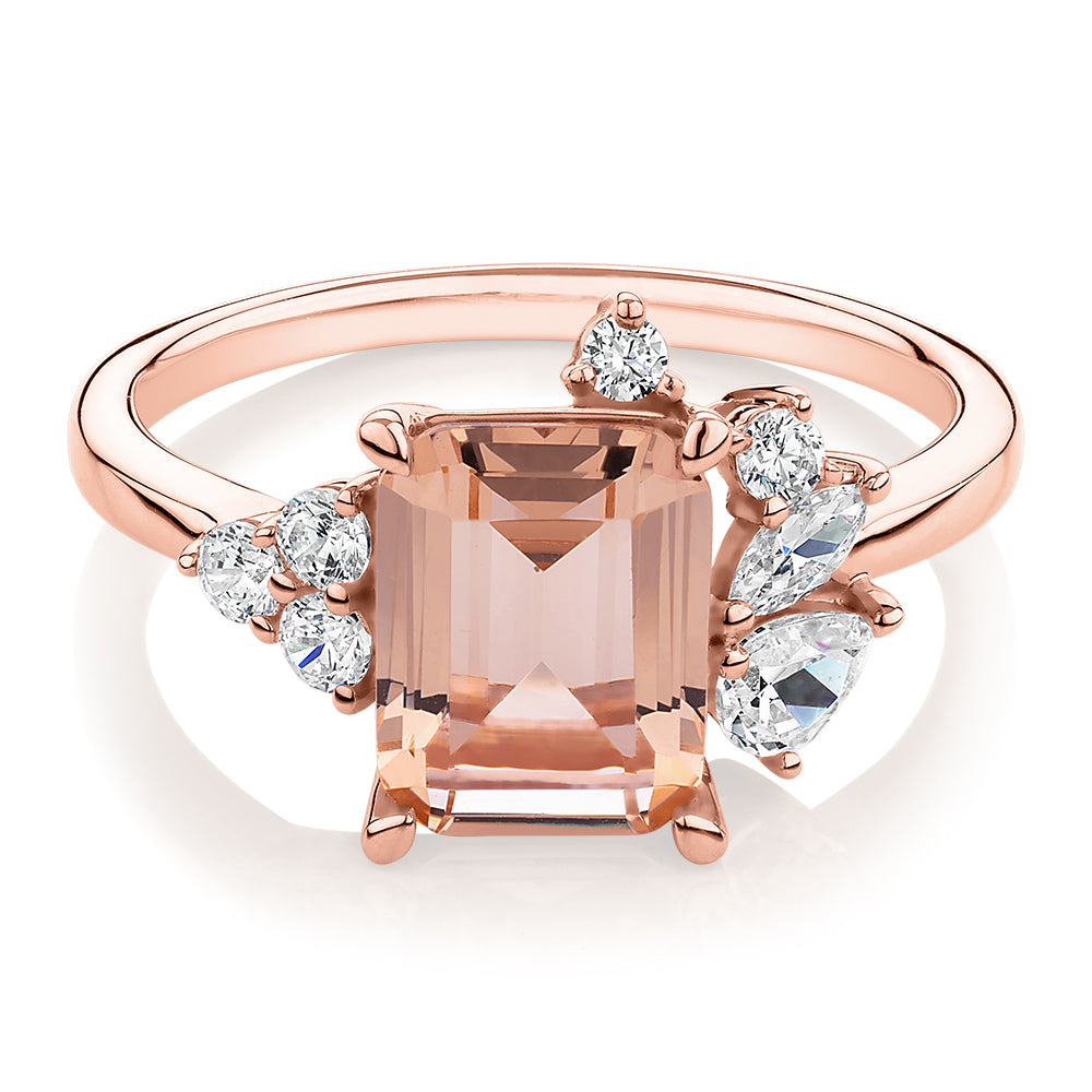 Emerald Cut and Round Brilliant shouldered engagement ring with morganite simulant and 0.45 carats* of diamond simulants in 10 carat rose gold