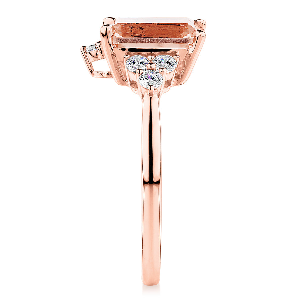 Emerald Cut and Round Brilliant shouldered engagement ring with morganite simulant and 0.45 carats* of diamond simulants in 10 carat rose gold