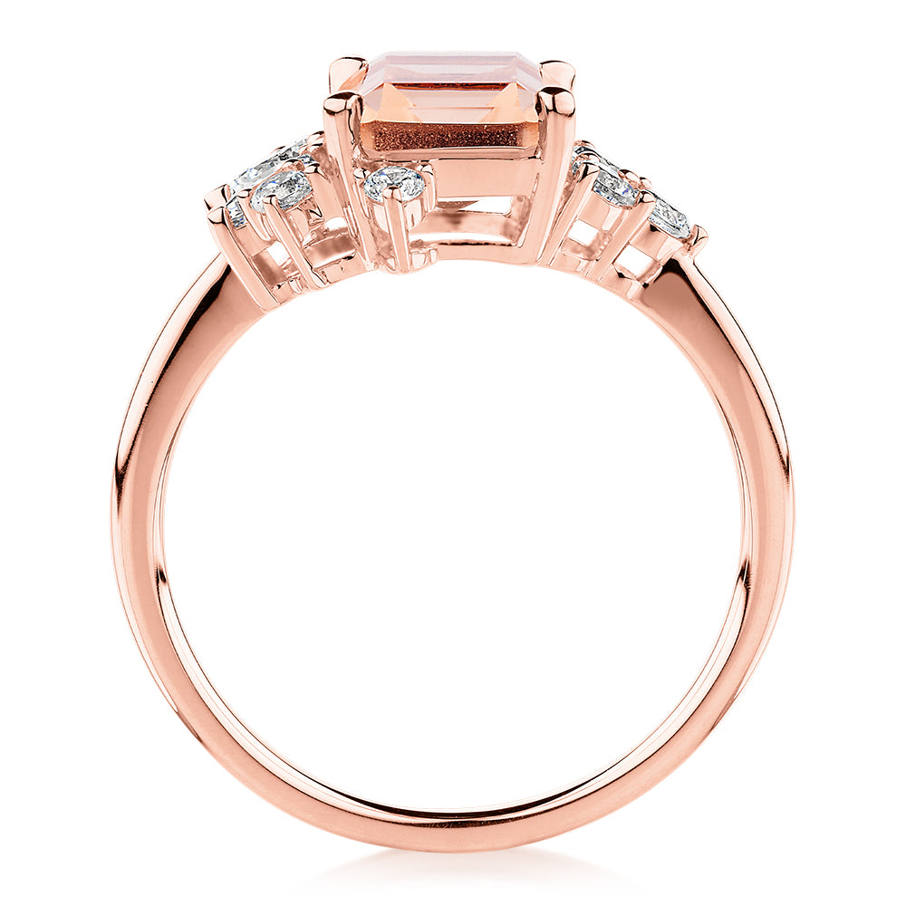 Emerald Cut and Round Brilliant shouldered engagement ring with morganite simulant and 0.45 carats* of diamond simulants in 10 carat rose gold