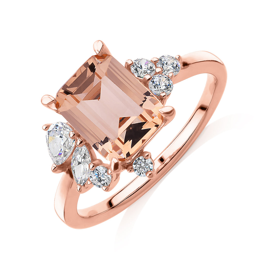 Emerald Cut and Round Brilliant shouldered engagement ring with morganite simulant and 0.45 carats* of diamond simulants in 10 carat rose gold