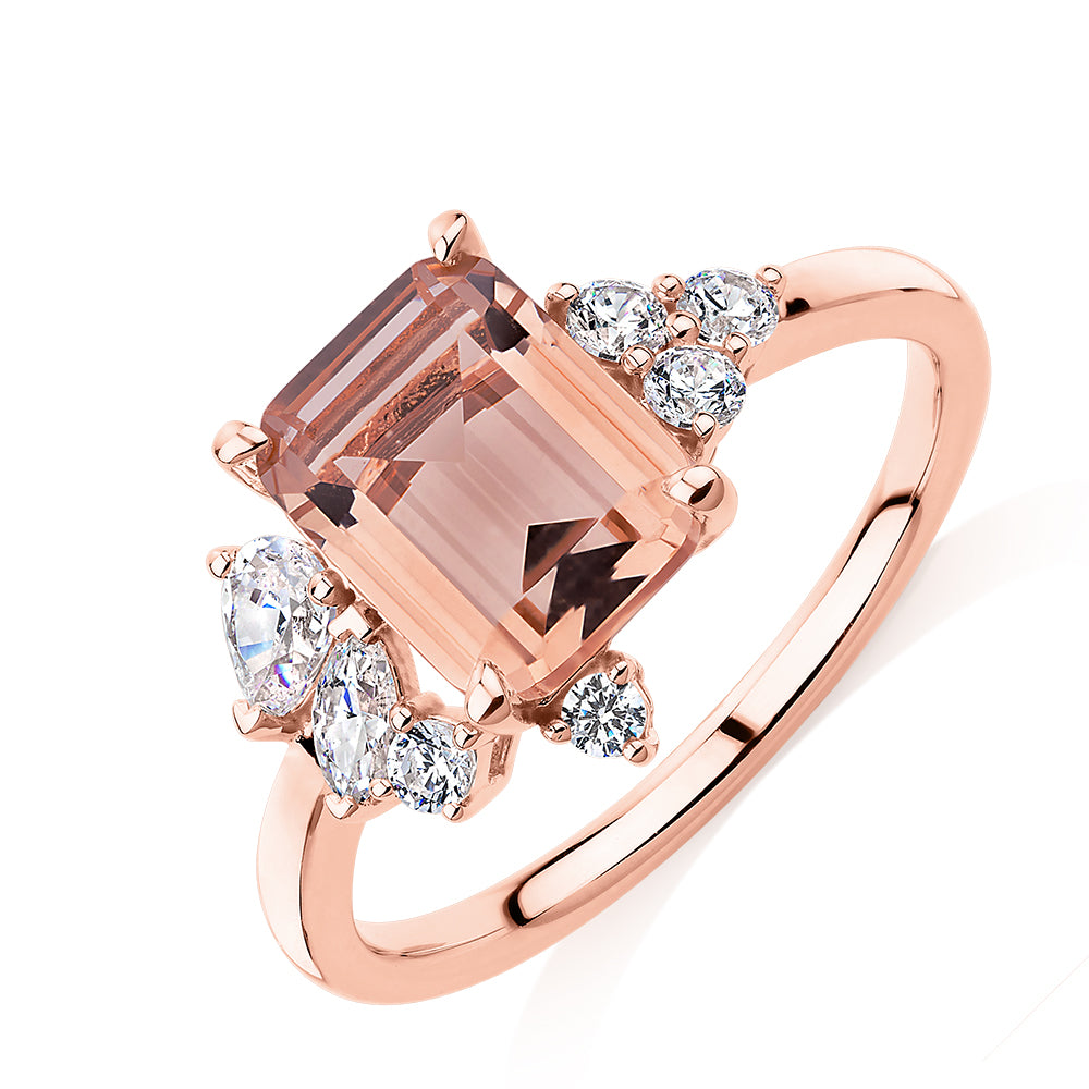 Emerald Cut and Round Brilliant shouldered engagement ring with morganite simulant and 0.45 carats* of diamond simulants in 10 carat rose gold