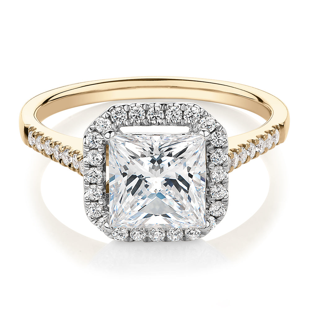 Princess Cut and Round Brilliant halo engagement ring with carats* of diamond simulants in 14 carat yellow and white gold