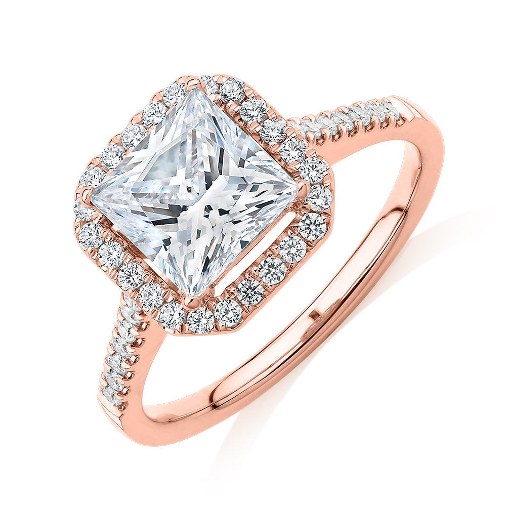 Princess Cut and Round Brilliant halo engagement ring with 2.21 carats* of diamond simulants in 14 carat rose gold