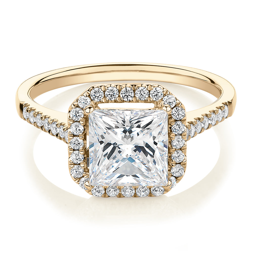 Princess Cut and Round Brilliant halo engagement ring with 2.21 carats* of diamond simulants in 14 carat yellow gold